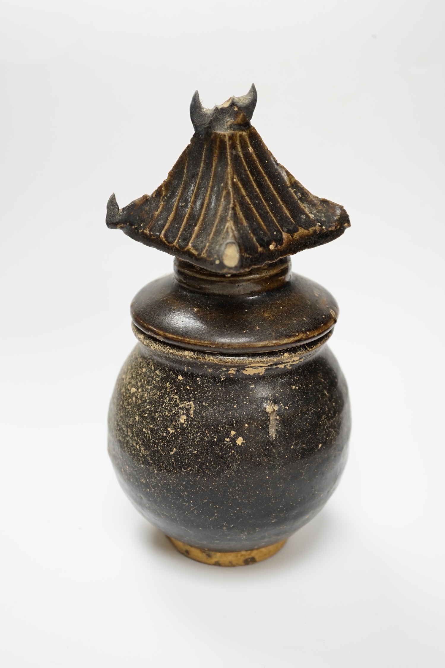A Khmer brown glazed jar and cover, Cambodia, 12th century, 18cm